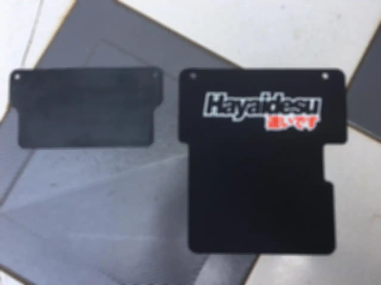Perbandingan panjang mud flap bawaan Yamaha NMAX (kiri) dengan keluaran Hayaidesu (kanan)
