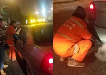 Tak Kuat Dingin, Pekerja Sanitasi Sampai Hangatkan Tangannya ke Knalpot Mobil