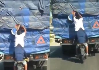 Bak Pemain Sirkus, Pencuri Ini Lakukan Atraksi di Atas Motor Sembari Ubek-Ubek Muatan Truk