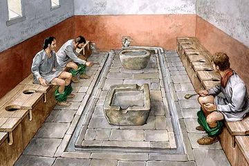 Gambar rekonstruksi jamban komunal di Benteng Romawi Housesteads (Vercovicium) di Tembok Hadrian. Situs ini sekarang dalam perawatan English Heritage (2010).
