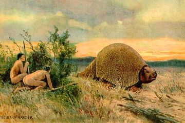Paleo-Indian sedang berburu glyptodont, kerabat dari armadillo yang hidup pada zaman Pleistosen.