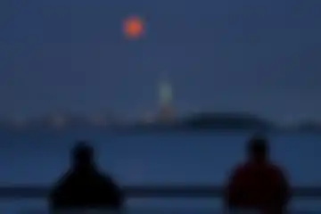 Foto menakjubkan menunjukkan Super Blood Moon raksasa bersinar di atas Kota New York Amerika Serikat.
