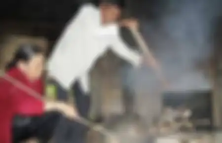 Thai Ngoc dan istrinya sedang memasak.
