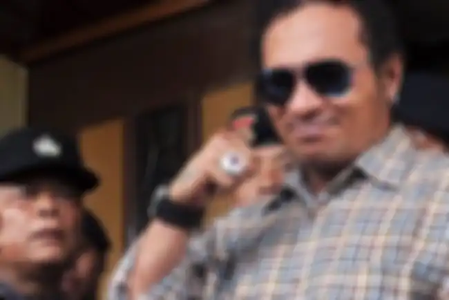 John Kei, yang dijuluki Godfather Jakarta, terlihat tertawa usai hakim membacakan vonis 15 tahun penjara.