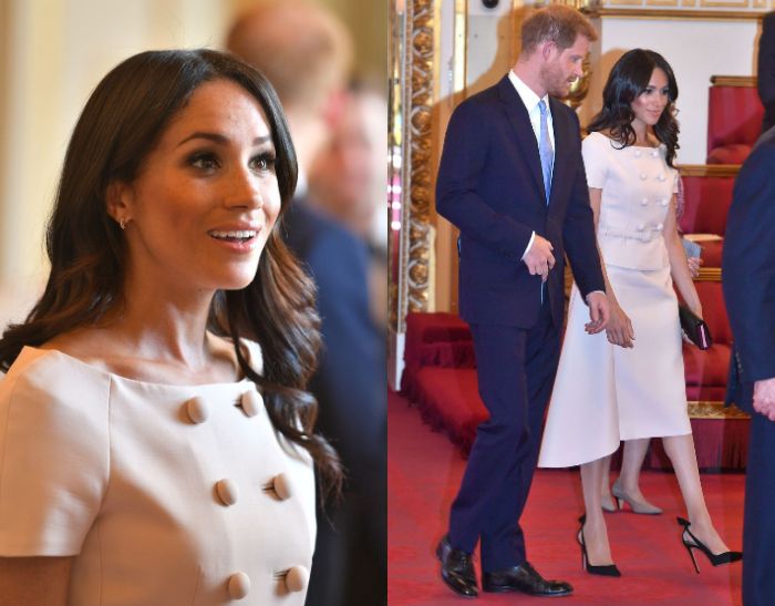 Meghan Markle mengenakan midi dress yang merupakan koleksi dari Prada