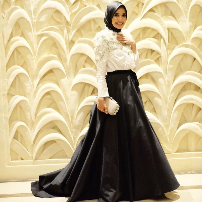 Busana kondangan ala Laudya Cynthia Bella dengan atasan warna putih dan aksen payet