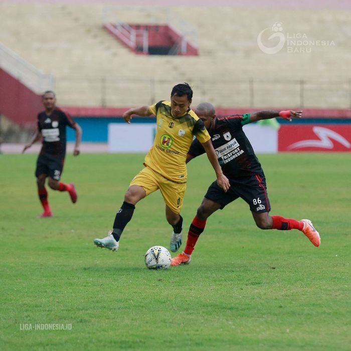 Pemain Persipura Jayapura, Boaz Solossa (kanan), berduel dengan pemain Barito Putera, Samsul Arif, dalam laga pekan ke-33 di Stadion Gelora Delta, Sidoarjo, Senin (16/12/2019).