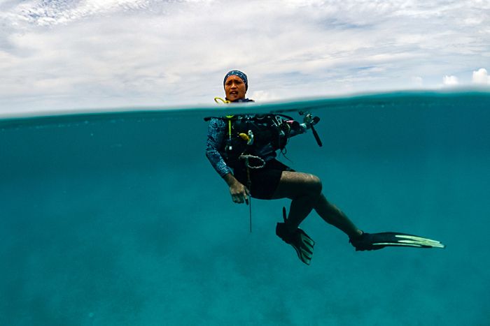GUARDING THE OCEANS  Githa Anasthasia, a conservation advocate, after a dive to observe manta ray behavior. Nature preservation brings economic and livelihood benefits to the community. 