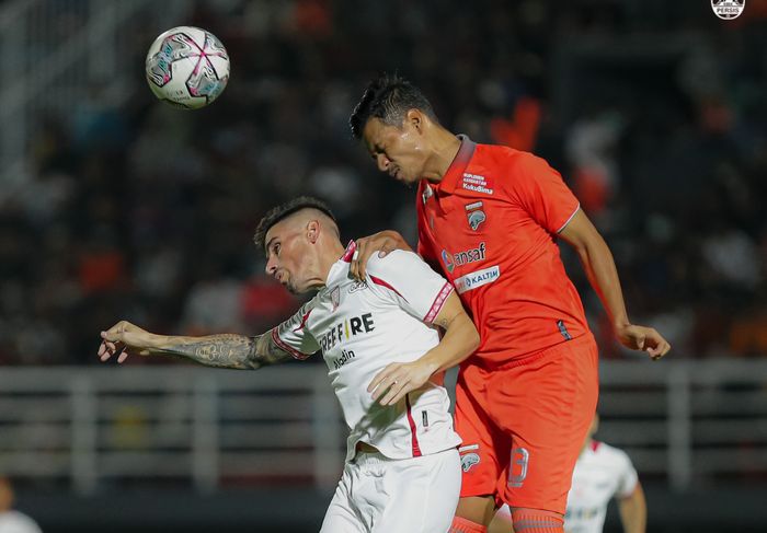 Striker Persis Solo, Fernando Rodriguez, berduel dengan bek Borneo FC Agung Prasetyo pada laga pekan ketujuh Liga 1 2022-2023.