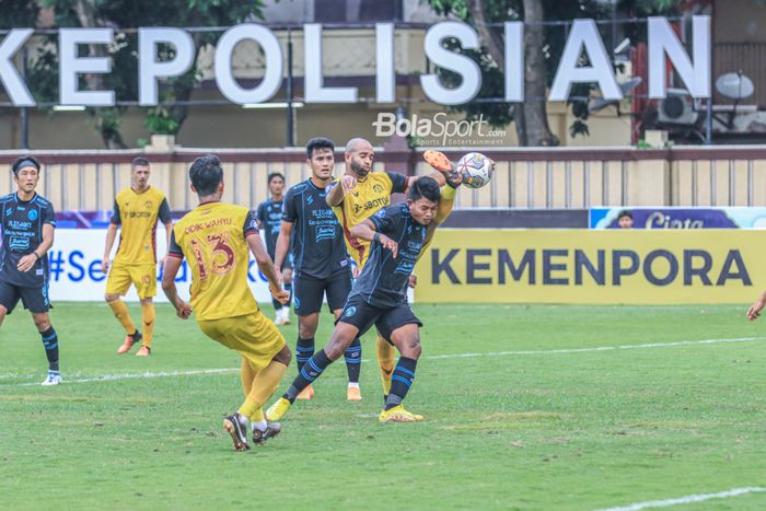 Bek asing Persikabo 1973, Lucas Gama Moreira alias Lucao (tengah), sedang menghalau bola yang mengarah kepada striker Arema FC bernama Dedik Setiawan (kanan) dalam laga pekan ke-31 Liga 1 2022 di Stadion PTIK, Blok M, Jakarta, Minggu (19/3/2023).