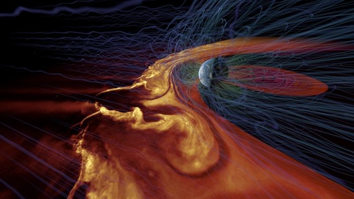 Visualisasi angin matahari yang dihasilkan komputer berinteraksi dengan medan magnet Bumi selama badai matahari yang kuat. Gangguan besar dapat mengganggu satelit komunikasi dan bahkan menyebabkan pemadaman listrik di permukaan bumi.