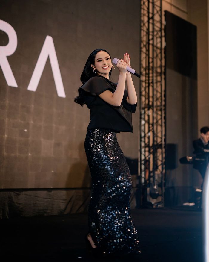 Lyodra tampil bernyanyi kenakan dress hitam desainer.