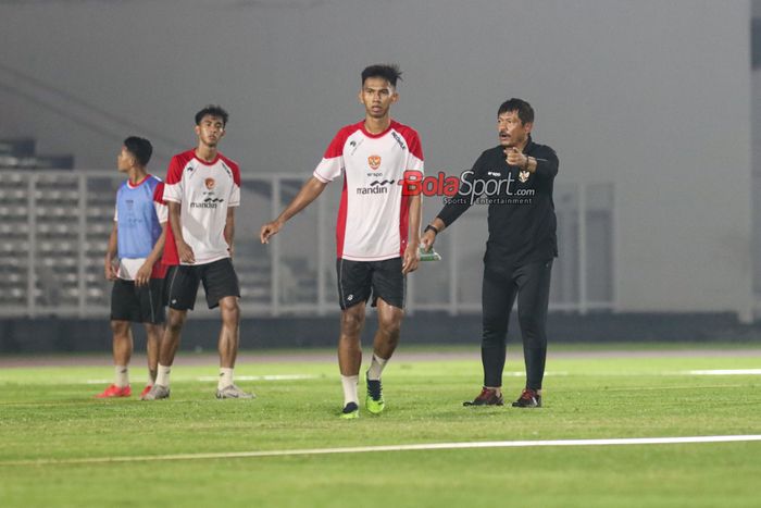 Pelatih timnas U-20 Indonesia, Indra Sjafri (kanan), sedang memantau para pemainnya berlatih di Stadion Madya, Senayan, Jakarta, Minggu (22/9/2024).