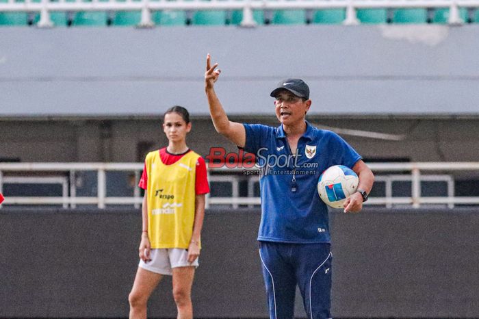 Pelatih Timnas Putri Indonesia, Joko Susilo, sedang memberikan intruksi kepada para pemainnya saat berlatih di Stadion Pakansari, Bogor, Jawa Barat, Rabu (30/.7/2025).