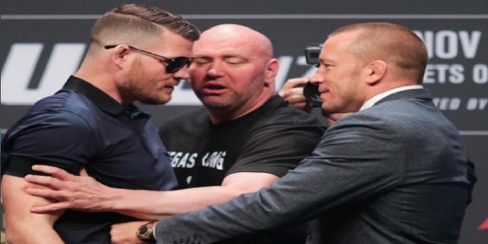 Michael Bisping (kiri) dan Georges St-Pierre (kanan) ditengahi oleh presiden UFC, Dana White.