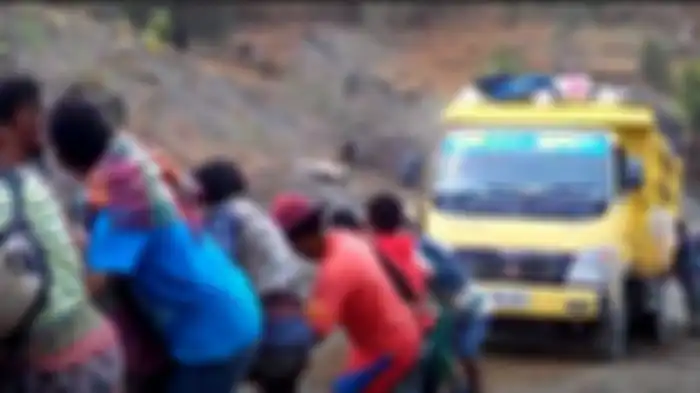 Infastruktur jalan di distrik Oecusse Timor Leste yang masih memprihatinkan. Masyarakat harus berjibaku menarik truk yang tak mampu menanjak di jalan yang rusak.