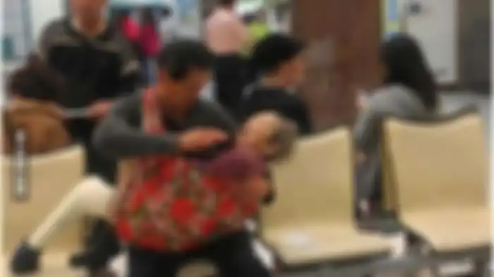 Seorang pria menggendong dan menyuapi ibunya di sebuah rumah sakit di Taiwan.