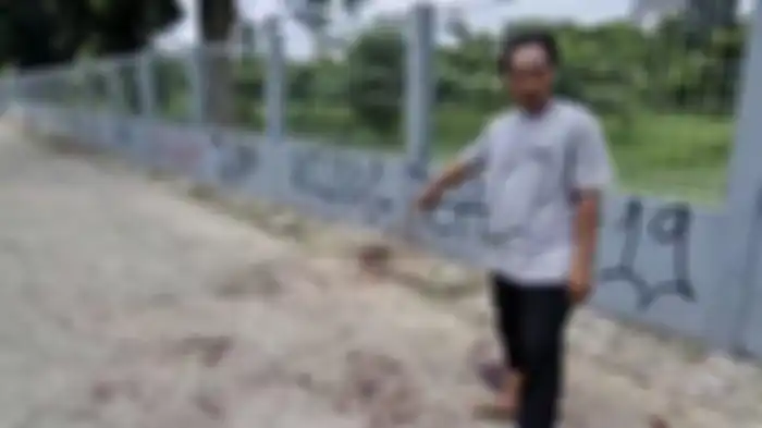 Seorang warga, Maulana menunjukkan lokasi pembacokan oleh kawanan begal motor. 