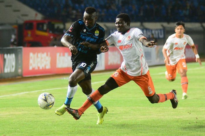 Striker Persib Bandung Ezechiel N'Douassel (kiri) ditempel ketat pemain Perseru Serui dalam penyisihan grup Piala Presiden 2019 di Stadion Si Jalak Harupat, Kabupaten Bandung, Selasa (12/3/2019) malam WIB.