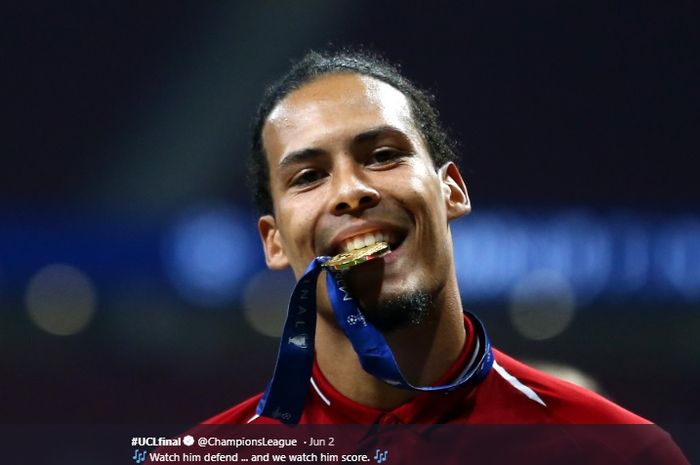 Bek tengah Liverpool, Virgil van Dijk, menggigit medali usai Liverpool menjuarai Liga Champions 2018-2019