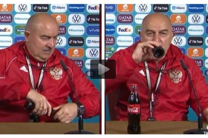 Pelatih timnas Rusia, Stanislav Cherchesov, menenggak botol minuman soda sponsor dalam jumpa pers Euro 2020.