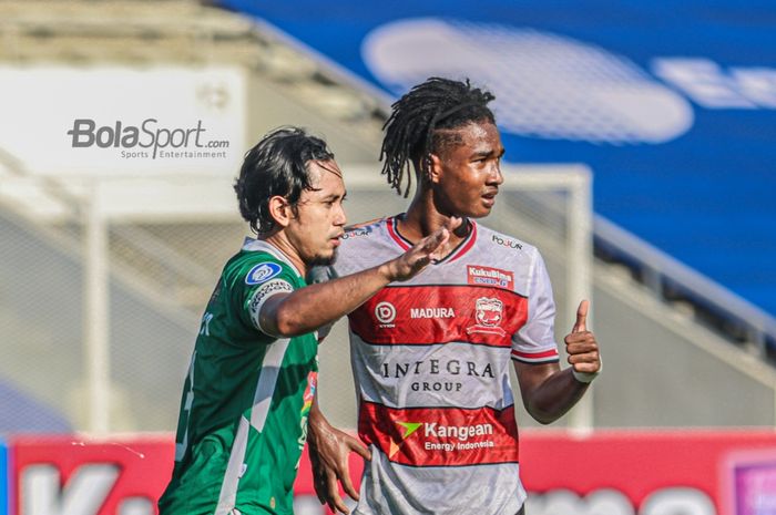 Bek PSS Sleman, Bagus Nirwanto (kiri), sedang mengawal pergerakan pemain sayap kanan Madura United, Ronaldo Kwateh (kanan), dalam laga pekan keempat Liga 1 2021 di Stadion Madya, Senayan, Jakarta, 25 September 2021.