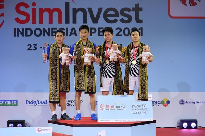 Pasangan ganda putra Indonesia, Marcus Fernaldi Gideon/Kevin Sanjaya Sukamuljo (kanan) di podium juara Indonesia Open 2021 di Bali International Convention Centre, Nusa Dua, Minggu (28/11/2021).