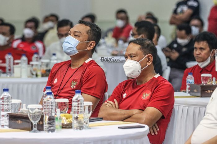 Menteri Pemuda dan Olahraga Republik Indonesia, Zainudin Amali (kanan), nampak serius mengamati pertandingan leg pertama Final Piala AFF 2020 dalam acara nonton bareng di  Kantor Kemenpora, Senayan, Jakarta, 29 Desember 2021.