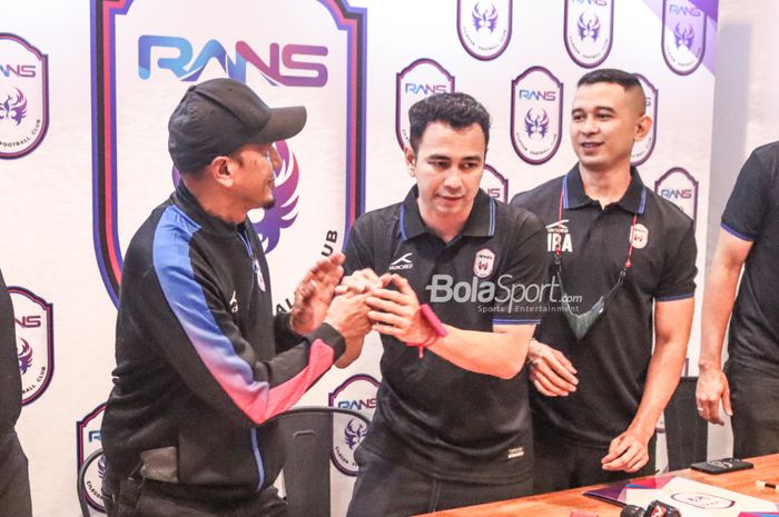 Raffi Ahmad sedang menyalami Rahmad Darmawan dalam pengesahannya sebagai pelatih RANS Cilegon FC di Nims Kaffe, Melawai, Jakarta, 11 April 2022.