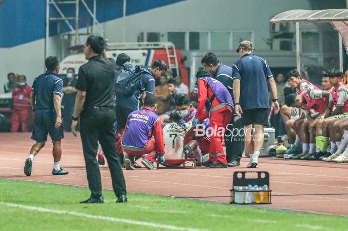 Pemain Persib Bandung, Beckham Putra Nugraha, sedang mendapatkan perawatan dari tim medis seusai mengalami cedera saat bertanding di Stadion Wibawa Mukti, Cikarang, Jawa Barat, 24 Juli 2022.