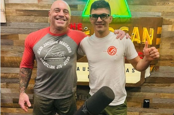 Joe Rogan (kiri), salah satu podcaster terpopuler di dunia, berpose dengan atlet ONE Championship Mikey Musumeci 