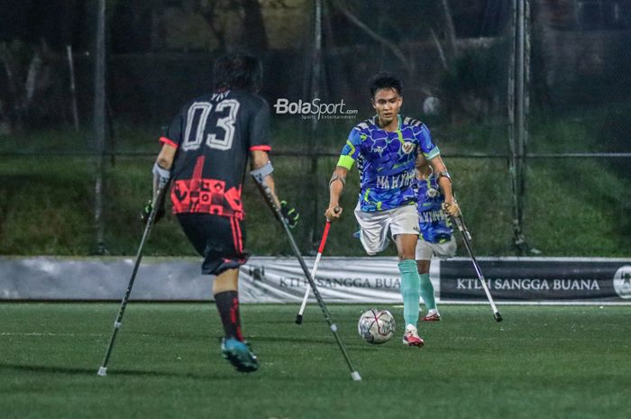 Pemain timnas amputasi Indonesia alias Garuda INAF, Aditya (kanan), sedang menguasai bola ketika bertanding di Lapangan Serena Hills, Lebak Bulus, Jakarta Selatan, 8 Agustus 2022.