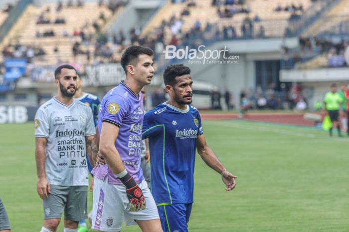 Gelandang Persib Bandung, Ricky Kambuaya (kanan), nampak merangkul kiper Bali United bernama Nadeo Argawinata (tengah) setelah sempat berselisih dalam laga pekan kenam BRI Liga 1-2022/2023.