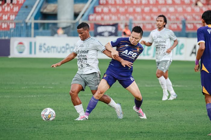 Pemain Bali United, Eber Bessa (kiri) mendapatkan kawalan kapten Persik, Arthur Irawan (kanan) dalam pekan ke-24 Liga  1 2022/2023.