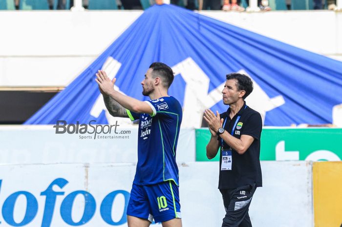 Pelatih Persib Bandung, Luis Milla (kanan) dan pemainnya bernama Marc Klok (kiri) sedang menyambut para suporter setelah laga pekan ke-29 Liga 1 2022 di Stadion Pakansari, Bogor, Jawa Barat, Rabu (8/3/2023).