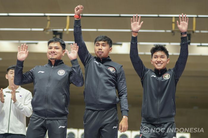 Petembak putra Indonesia Muhammad Sejahtera (tengah) bersama dua rekannya Irfani Julio (kiri) dan Muhammad Badri Akbar (kanan) meraih medali perunggu nomor 10m running target mixed run team di Fuyang Yinhu Sports Centre, Selasa (26/9/2023).