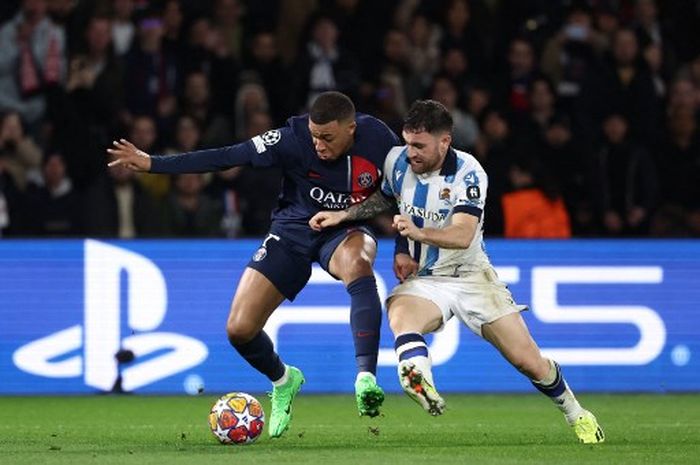 Striker PSG, Kylian Mbappe, berduel dengan bek Real Sociedad, Javier Galan, dalam laga leg pertama babak 16 besar Liga Champions, Rabu (14/2/2024) di Parc des Princes, Paris.