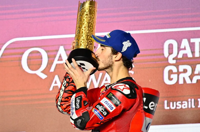 Francesco Bagnaia (Ducati Lenovo) mencium trofi MotoGP Qatar 2024 usai jadi pemenang pada balapan di Sirkuit Lusail, Qatar, Minggu (10/3/2024) malam waktu setempat.