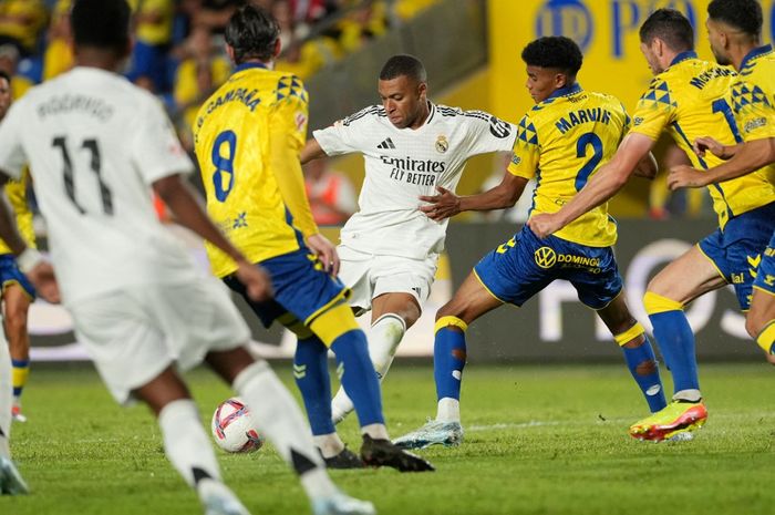 Penyerang Real Madrid, Kylian Mbappe, dikepung oleh para pemain Las Palmas dalam lanjutan Liga Spanyol 2024-2025.