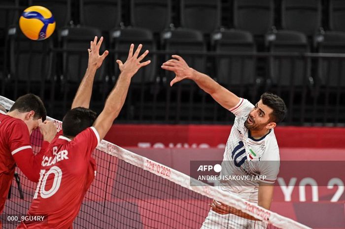 Pemain timnas Iran, Amir Ghafour, melakukan spike ke arah pertahanan Kanada pada babak penyisihan bola voli putra Olimpiade Tokyo 2020 di Ariake Arena, Tokyo, Jepang, 28 Juli 2021. 