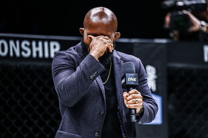 Demetrious Johnson menyeka air matanya ketika mengumumkan pensiun dari MMA di panggung ONE Championship, Sabtu (7/9/2024) di Denver.