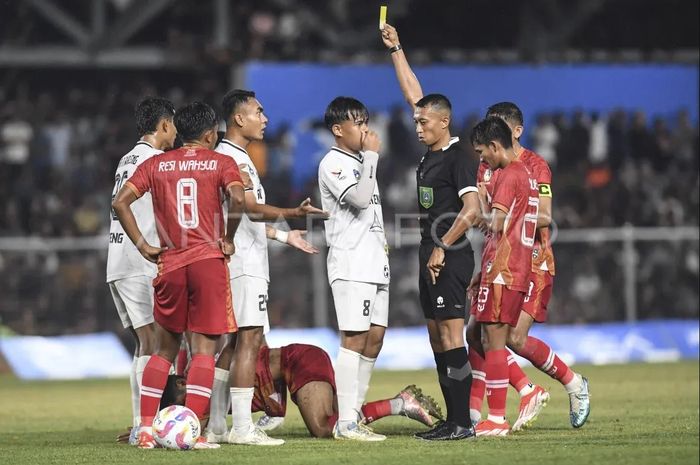 Wasit Eko Agus Sugiharto (kedua kanan) memberikan kartu kuning kepada pesepak bola Sulawesi Tengah Ichansyah (ketiga kiri) saat melawan tim Aceh pada pertandingan babak 8 besar PON XXI Aceh-Sumut 2024 di Stadion H Dimurthala, Banda Aceh, Aceh, Sabtu (14/9/2024).