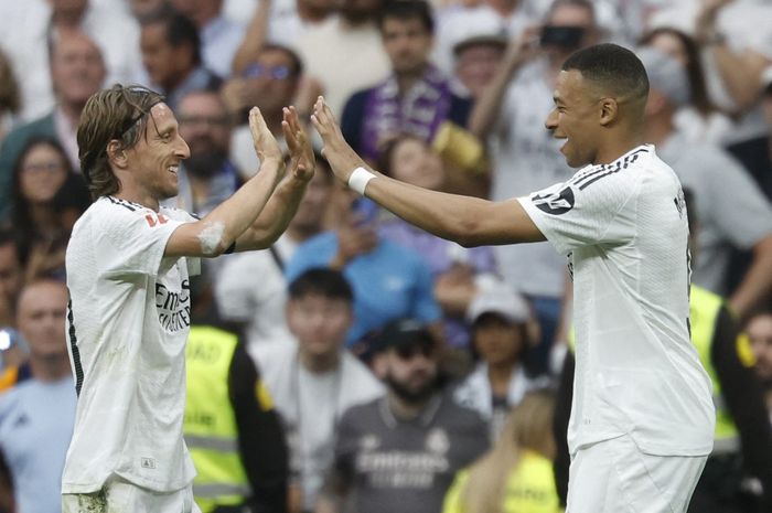 Luka Modric (kiri) memberikan respons terhadap rumor dirinya telah sepakat bergabung AC Milan.