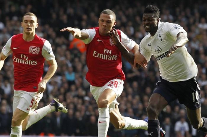 Striker Tottenham Hotspur, Emmanuel Adebayor (kanan), berduel melawan Kieran Gibbs (tengah) di Emirates Stadium, London, pada 26 Februari 2012. 