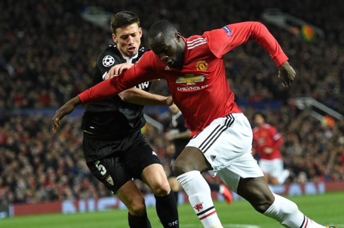 Bek Sevilla, Clement Lenglet (kiri), berduel dengan striker Manchester United, Romelu Lukaku, dalam laga leg kedua babak 16 besar Liga Champions di Stadion Old Trafford, Manchester, Inggris, pada 13 Maret 2018.