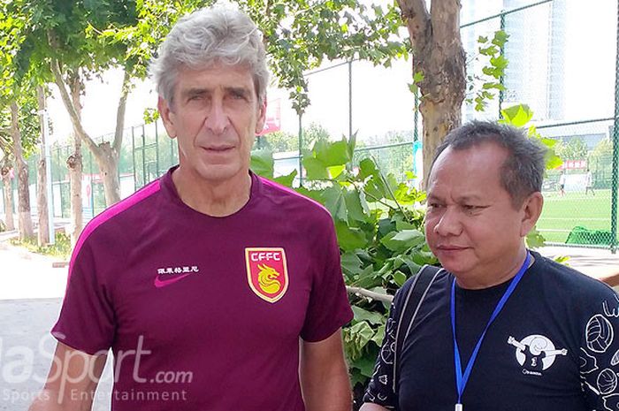 Penulis berpose dengan pelatih tim Hebei China Fortune, Manuel Pellegrini.