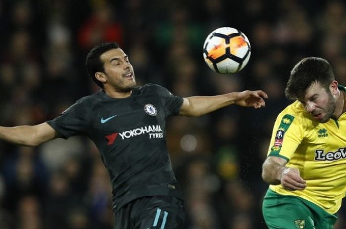 Gelandang Chelsea, Pedro (kiri) berduel dengan bek Norwich City, Grant Hanley (kanan) dalam laga putaran ketiga Piala FA antara kedua tim di Stadion Carrow Road pada Minggu (7/1/2017) dini hari WIB.