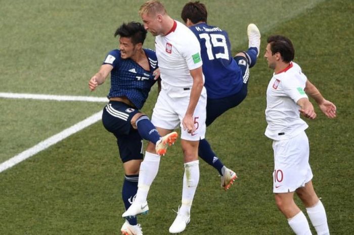 Bek Polandia, Jan Badnarek (dua dari kiri), menyundul bola ke gawang Jepang dalam partai Grup H Piala Dunia 2018 di Volgograd Arena, 28 Juni 2018.