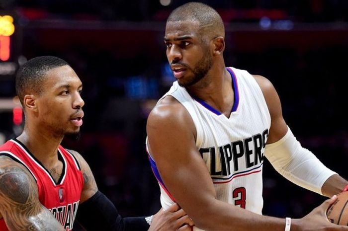 Pebasket Los Angeles Clippers, Chris Paul (jersey putih, #3), dijaga oleh pemain Portland Trail Blazers, Damian Lillard (jersey merah, #0), pada pertandingan musim reguler NBA di Staples Center, Los Angeles, California, Amerika Serikat, Senin (12/12/2016). Clippers menang 121-120.