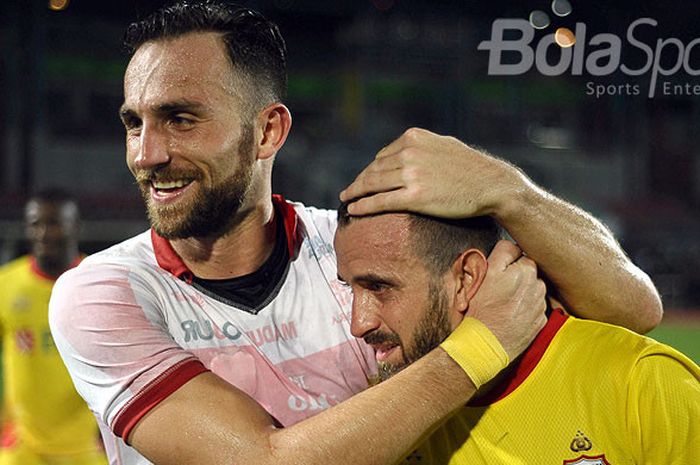 Striker Bhayangkara FC, Ilija Spasojevic (kiri), memeluk rekan setimnya, Paulo Sergio, saat merayakan kemenangan timnya atas Madura United dalam laga pekan ke-33 di Stadion Gelora Bangkalan, Jawa Timur, Rabu (08/11/2017).